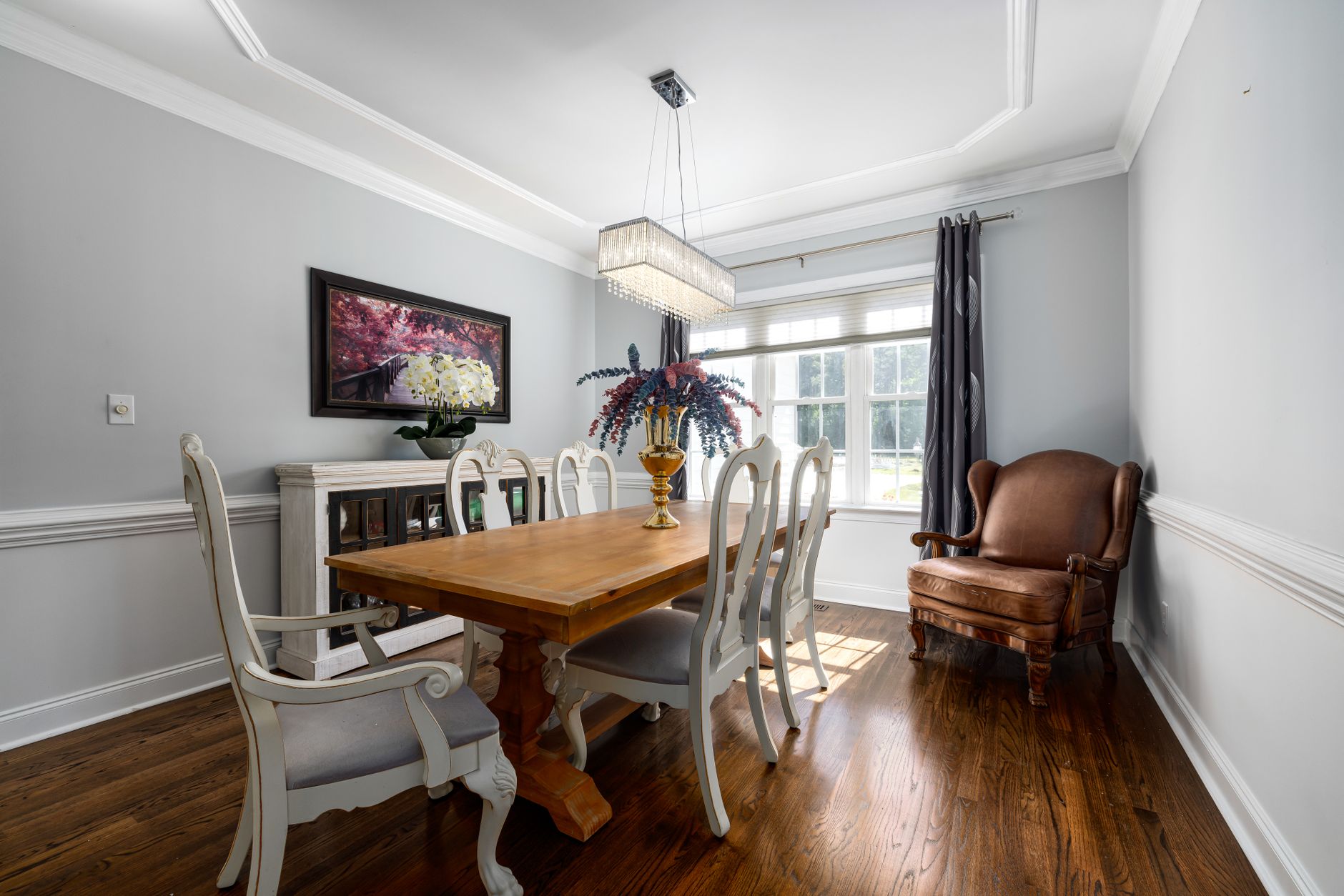 brown wooden dining table with white chairs